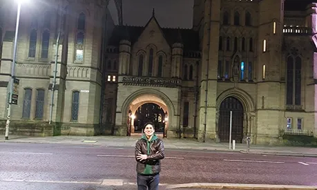 man in front of university