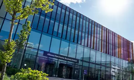 The front of the Alliance Manchester Business School building in the sunshine