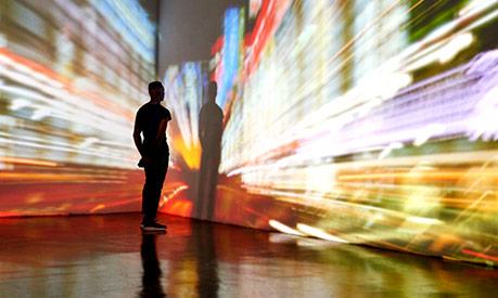 man looking at large screen with bright colours