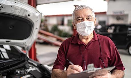 senior auto repair man wearing mask