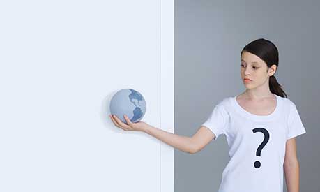 Woman holding globe and wearing t-shirt with question mark on