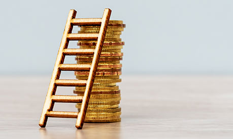 stack of coins holding up a ladder