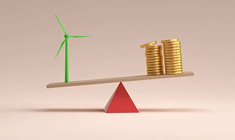 A scale with coins on one side and a wind turbine on the other