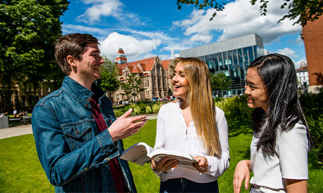 students at Manchester University campus smiling 