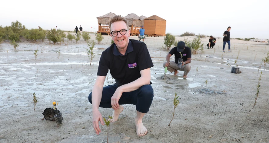 Professor Ken McPhail planting mangrove trees in Dubai