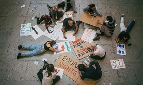 A group of protestors preparing signs for an upcoming march